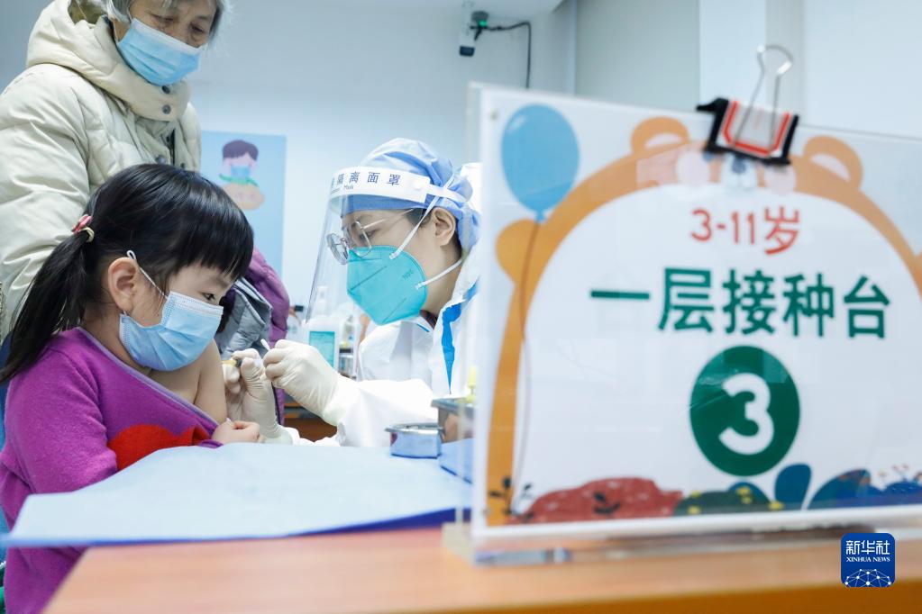 　家长带着孩子在北京新街口街道新冠疫苗接种点接种疫苗（12月9日摄）。新华社记者 张玉薇 摄.jpg